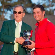 US golfer Bryson DeChambeau (R) receives a trophy from Billy Payne at the end of the 80th Masters Golf Tournament at the Augusta National Golf Club on April 10, 2016, in Augusta, Georgia.
England's Danny Willett won the 80th Masters at Augusta National on Sunday for his first major title. He was trailing defending champion Jordan Spieth by five strokes around the turn, but stormed down the back nine to overhaul the American. Willett is the first Englishman since Nick Faldo 20 years ago to win the Masters and only the second all-time. / AFP / Jim Watson        (Photo credit should read JIM WATSON/AFP via Getty Images)