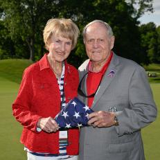 DUBLIN, OHIO - JUNE 07: Jack Nicklaus and his wife, Barbara Nicklaus, hold the folded American flag together during the Folds of Honor Friday Ceremony after the second round of the Memorial Tournament presented by Workday at Muirfield Village Golf Club on June 7, 2024 in Dublin, Ohio. (Photo by Ben Jared/PGA TOUR via Getty Images)