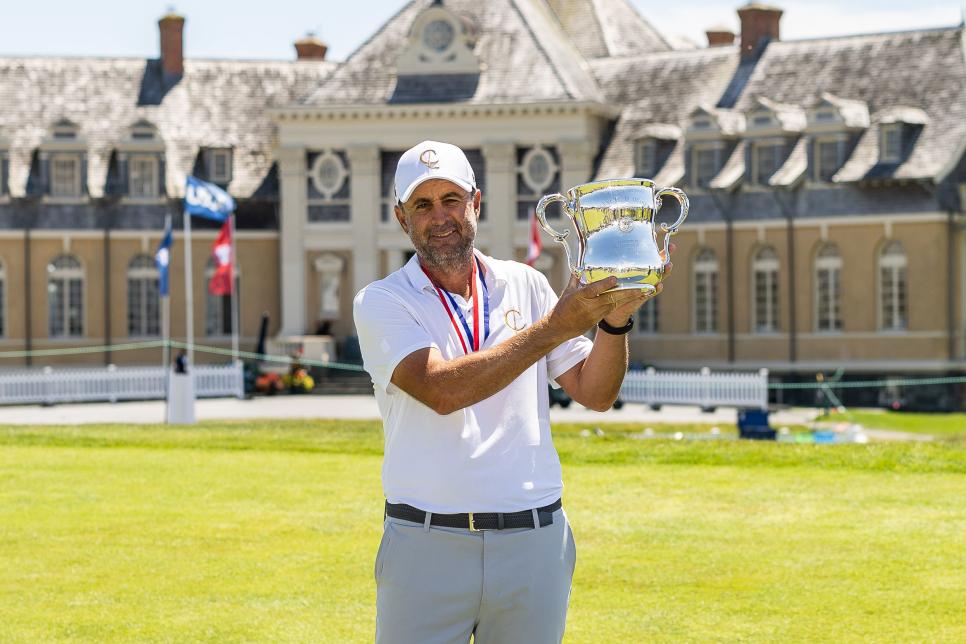 NEWPORT, RHODE ISLAND - JULY 01: Richard Bland of England receives his trophy after winning during the final round of the U.S. Senior Open Championship at Newport Country Club on July 01, 2024 in Newport, Rhode Island. (Photo by Brennan Asplen/Getty Images)
