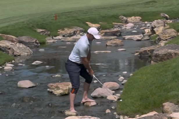 Rory McIlroy hits barefoot shot while standing on rocks after breaking driver shaft on tee box