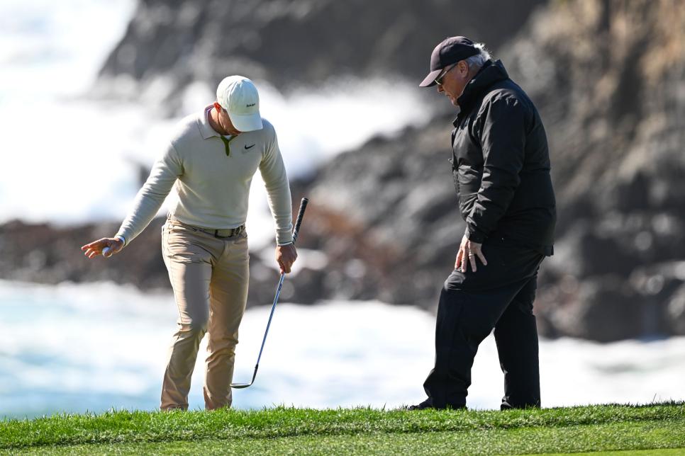 PEBBLE BEACH, CALIFORNIA - FEBRUARY 02: Rory McIlroy of Northern Ireland chats with a rules official at the eighth hole during the second round of AT&T Pebble Beach Pro-Am at Pebble Beach Golf Links on February 2, 2024 in Pebble Beach, California. (Photo by Tracy Wilcox/PGA TOUR via Getty Images)