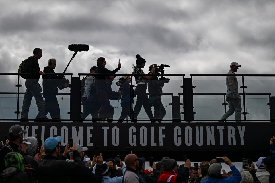 NORTH BERWICK, SCOTLAND - JULY 16:  Rory McIlroy of Northern Ireland and members of the media are silhouetted above the “Welcome to Golf Country” sign as he arrives at the trophy presentation following his victory in the final round of the Genesis Scottish Open at The Renaissance Club on July 16, 2023 in North Berwick, Scotland. (Photo by Keyur Khamar/PGA TOUR via Getty Images)