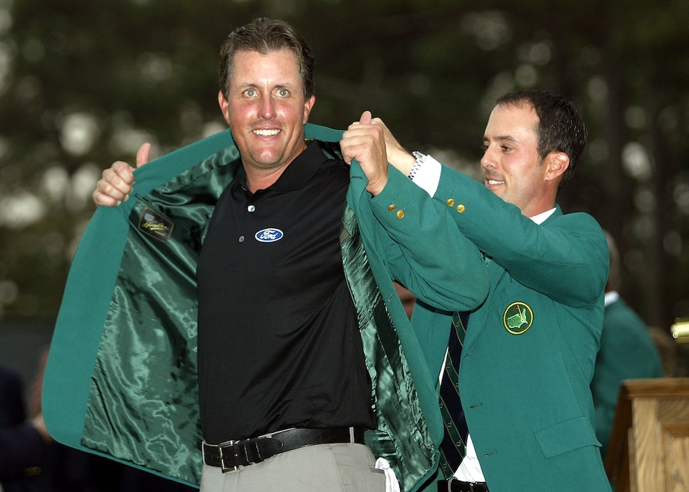 AUGUSTA, GA - APRIL 11:  Phil Mickelson of the U.S. is presented the green jacket by 2003 Masters champion Mike Weir of Canada after the final round of the Masters on April 11, 2004 at the Augusta National Golf Club in Augusta, Georgia.  (Photo by Harry How/Getty Images)