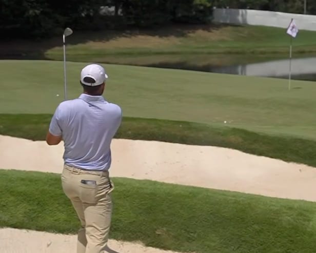 Watch Scottie Scheffler’s bunker shot bounce off a sprinkler and roll into the water