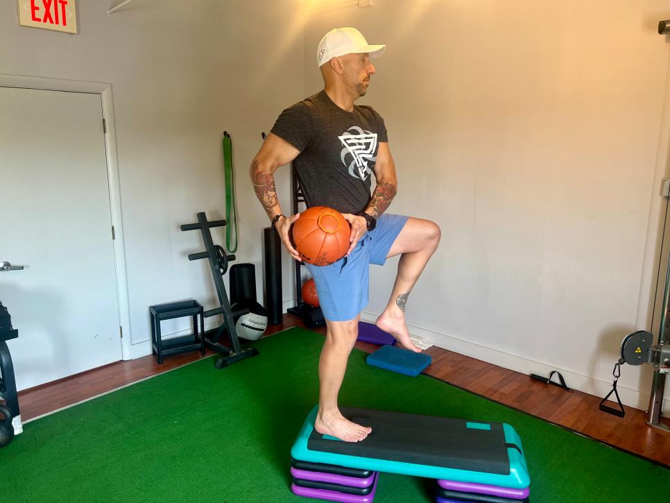 https://www.golfdigest.com/content/dam/images/golfdigest/fullset/fitness-2024/Gozbekian step-up with med-ball chop 2.jpeg