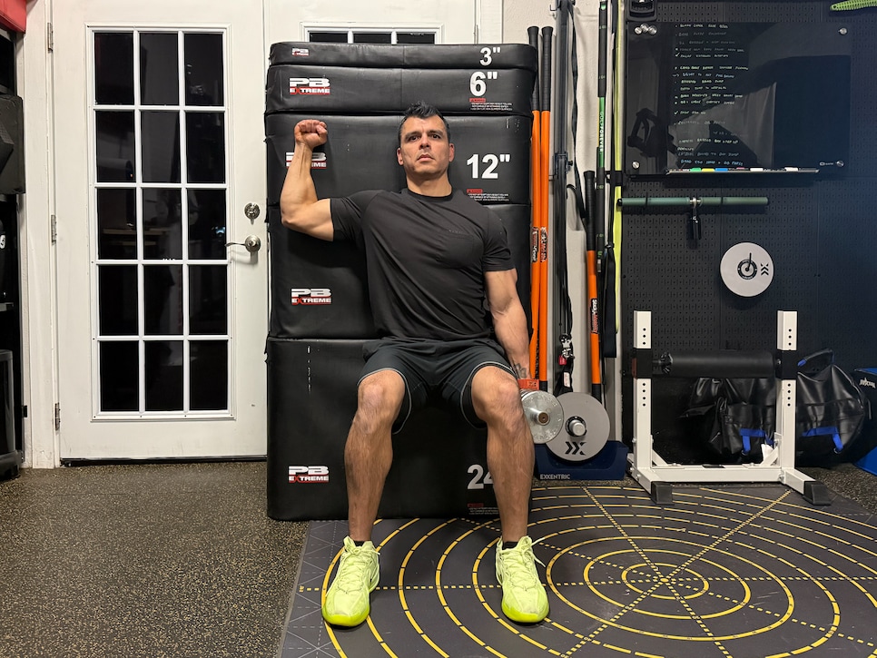 https://www.golfdigest.com/content/dam/images/golfdigest/fullset/fitness-2026/Avalos dumbbell wall squat with external rotation isometric hold.png