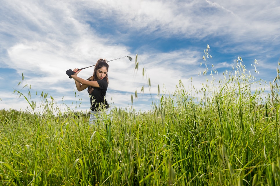 woman hitting out of fescue